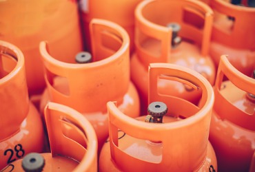 Numerous orange propane tanks provided by a Propane Supplier in Peoria IL