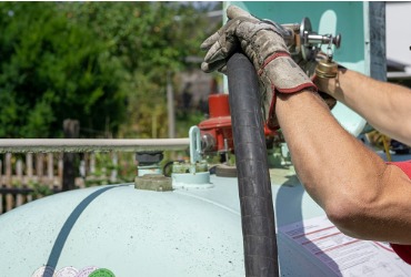 man filling the domestic gas tank