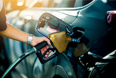 A man refueling a car with Gasoline in Peoria IL