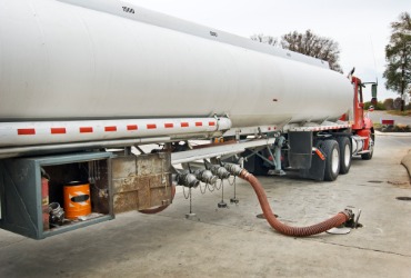 A truck fueling a gas station during a Gasoline Delivery for Pekin IL