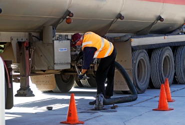 A man filling up a gas station tank during Fuel Delivery in Peoria IL