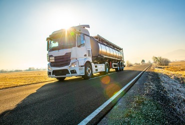 Truck driving down the road delivery gasoline