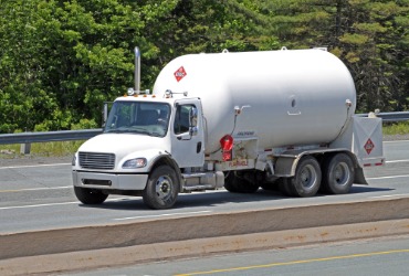 Propane delivery truck driving down the road