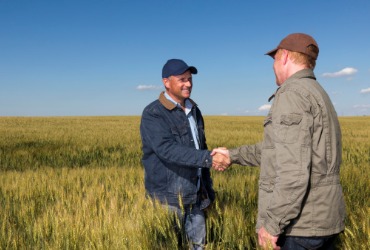 A delivery guy shakes hands with a farm after getting Fuel Delivery to Woodford County IL