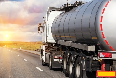 A truck on the highway performs Fuel Delivery for Woodford County IL