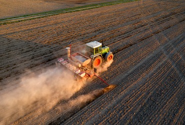 A tractor seeds on a farm after the farmer received Propane Refills in Woodford County IL