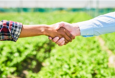 A farmer and delivery guy shake hands after providing Fuel Delivery in Woodford County IL