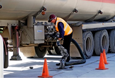 A big tanker filling up a gas station's supply of diesel fuel during diesel delivery in Illinois